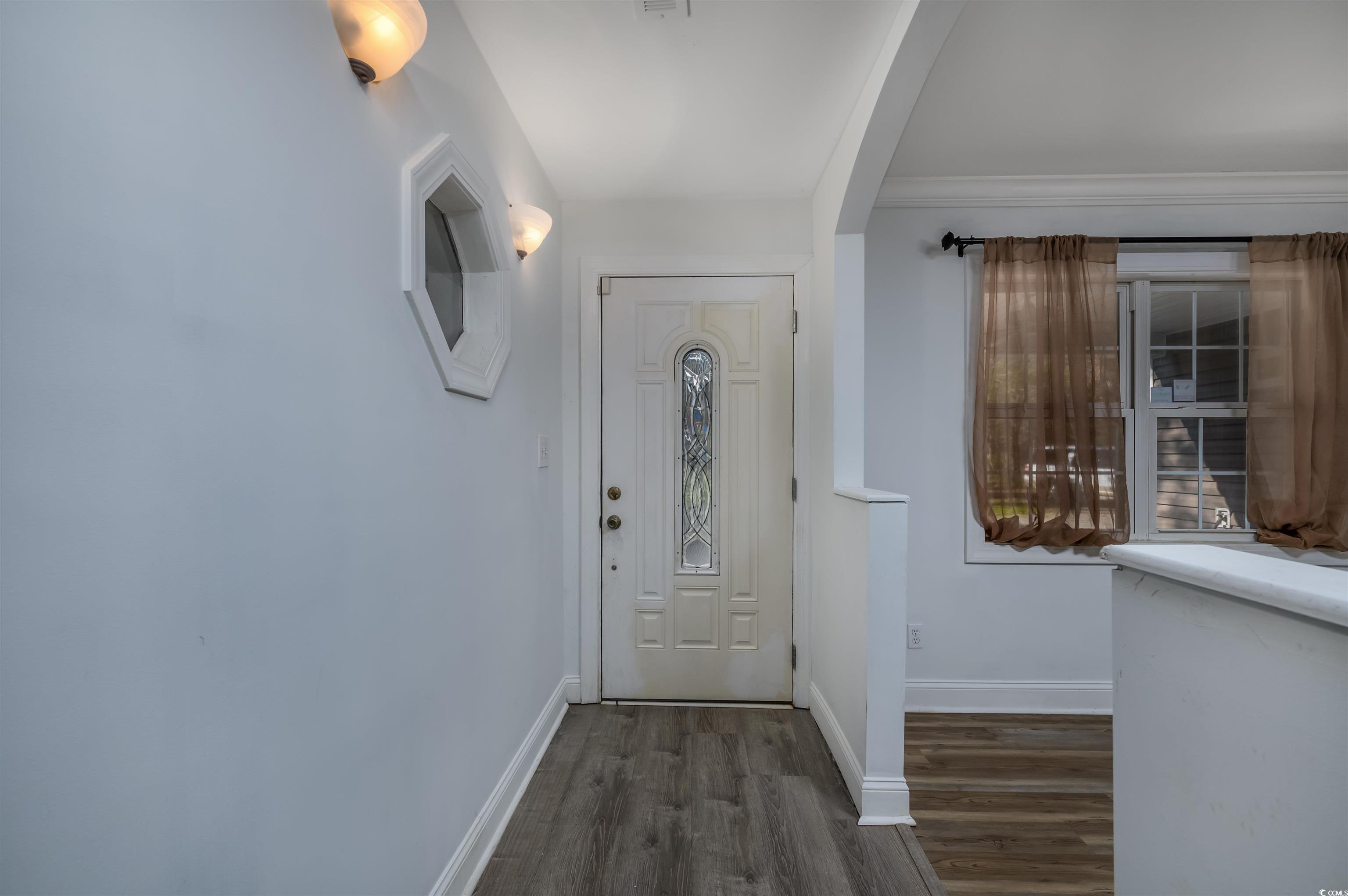 6252 Salem Road Myrtle Beach, SC 29588 - Photo 24 of 39 Entryway with crown molding and dark wood-type flooring