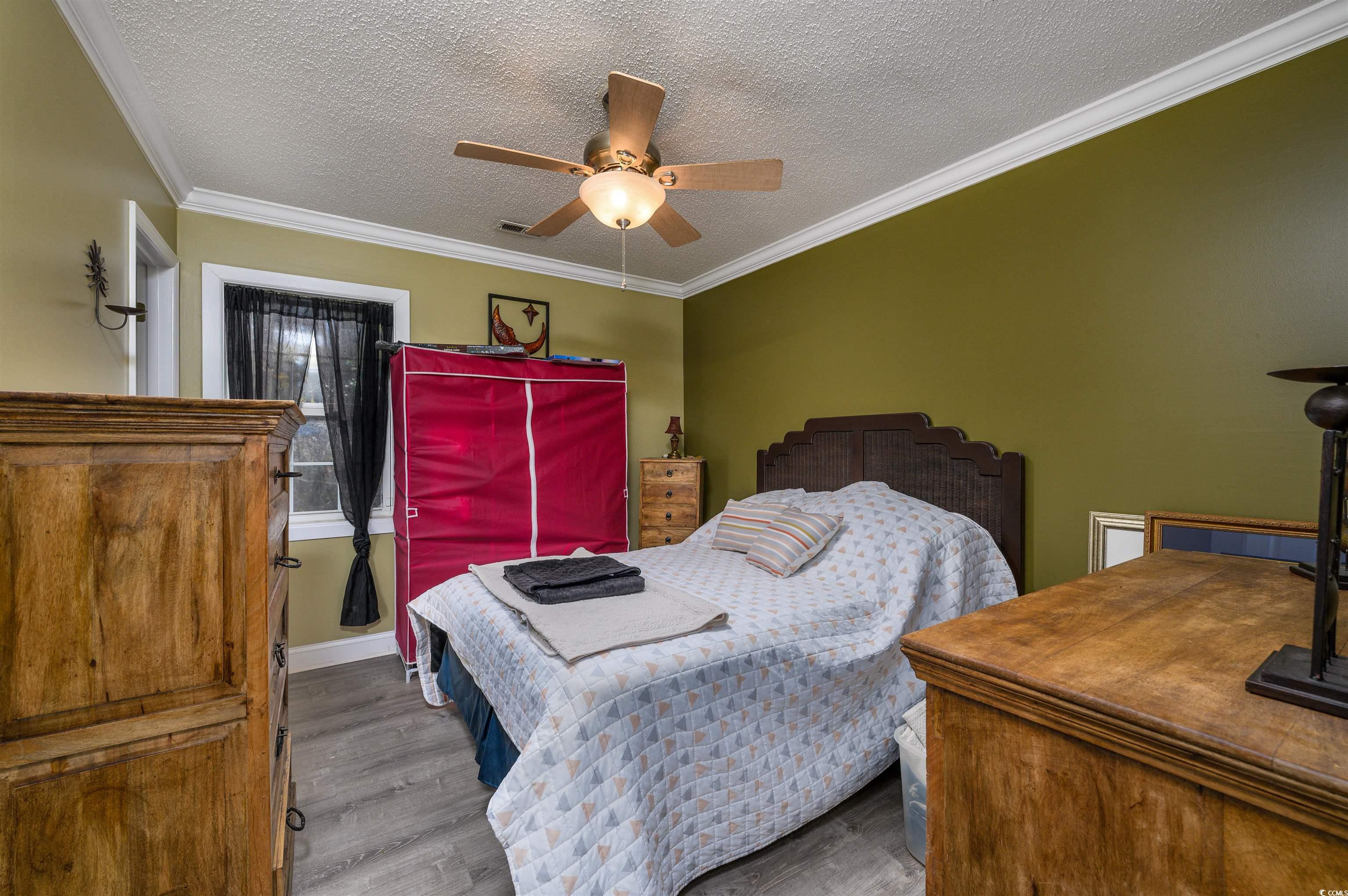 6252 Salem Road Myrtle Beach, SC 29588 - Photo 33 of 39 Bedroom featuring hardwood / wood-style floors, a textured ceiling, ceiling fan, and ornamental molding