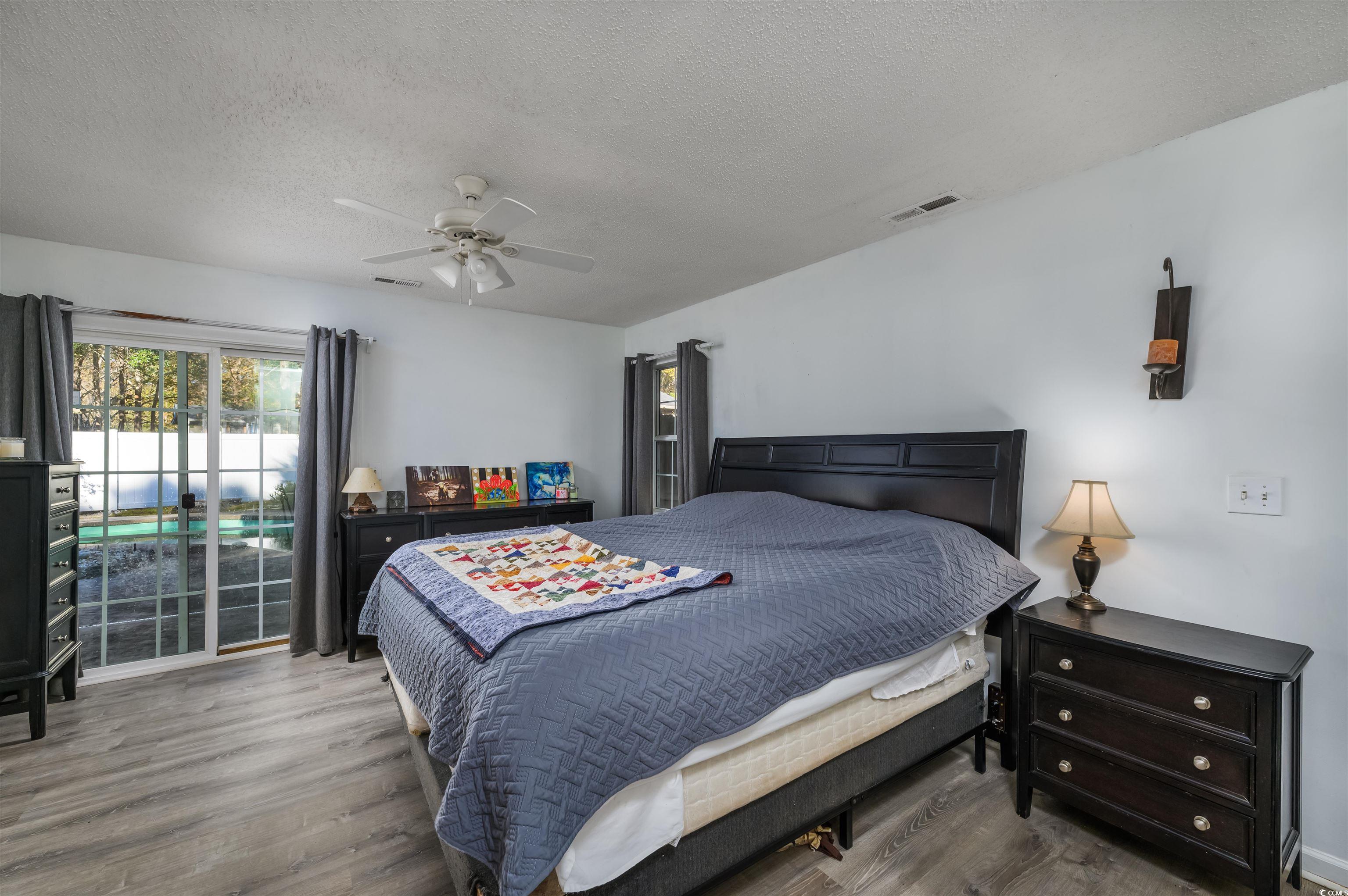 6252 Salem Road Myrtle Beach, SC 29588 - Photo 36 of 39 Bedroom featuring hardwood / wood-style floors, ceiling fan, and a textured ceiling
