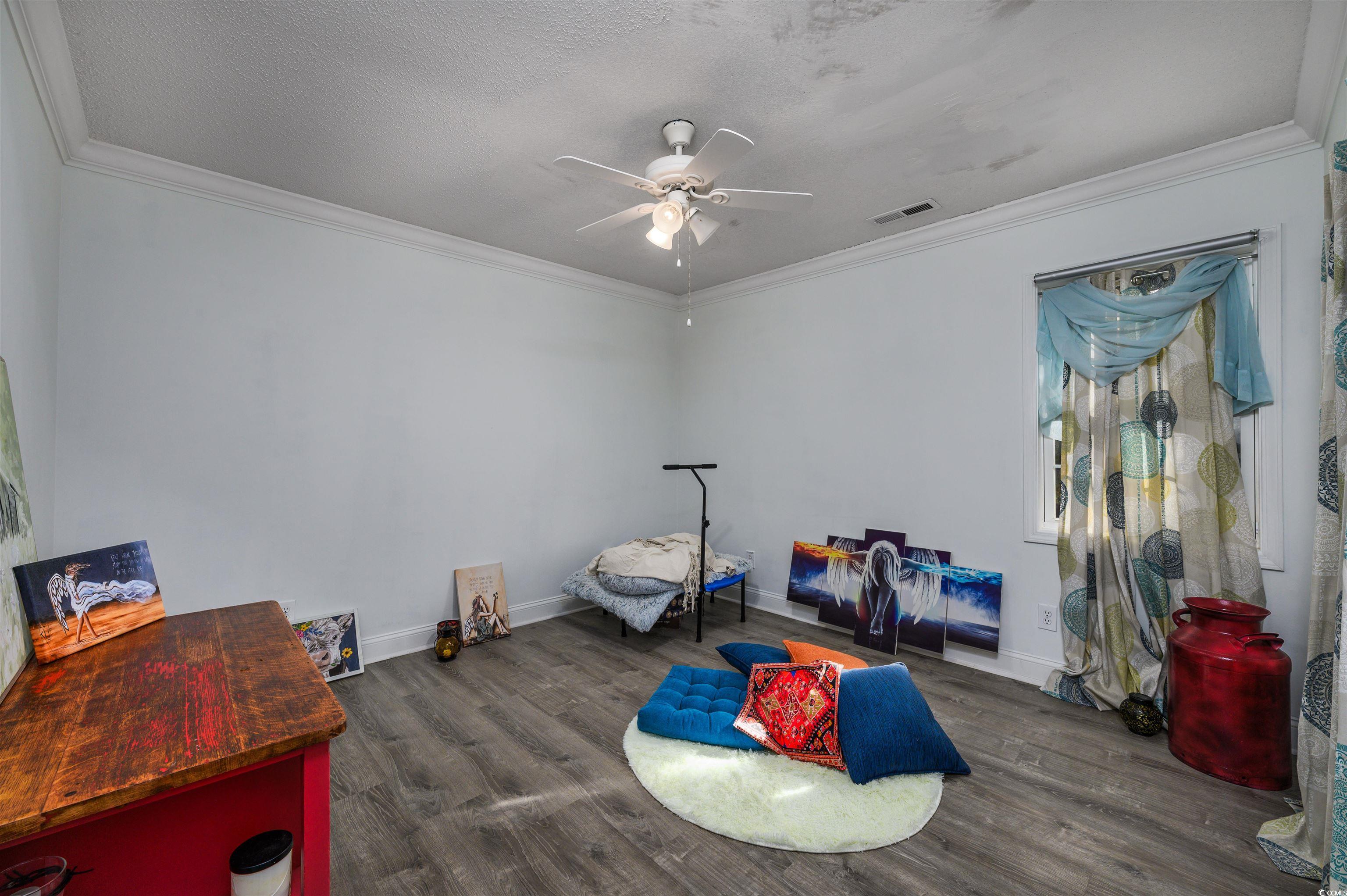 6252 Salem Road Myrtle Beach, SC 29588 - Photo 38 of 39 Exercise area with ornamental molding, a textured ceiling, and dark wood-type flooring