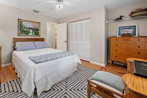 a living room with a bed furniture and painting on the wall