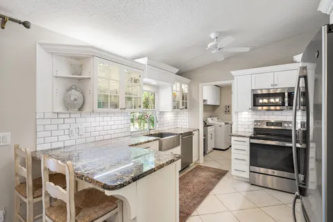 a kitchen with stainless steel appliances granite countertop a sink and cabinets