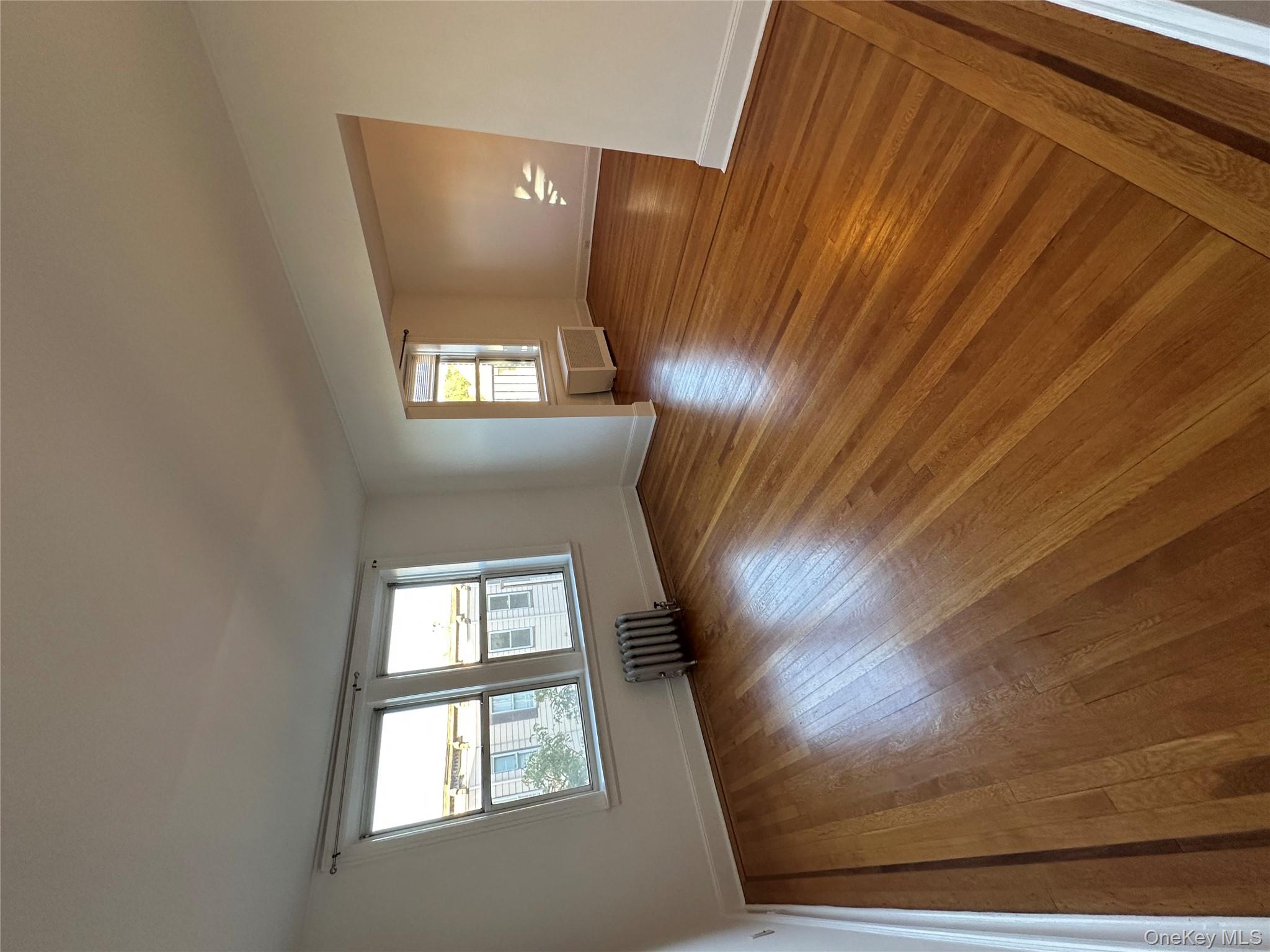 40 Fairview Avenue, Unit 5 Tuckahoe, NY 10707 - Photo 1 of 1 a view of an empty room with wooden floor and a window
