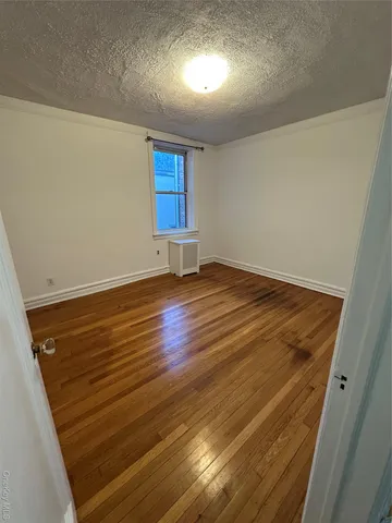 an empty room with wooden floor