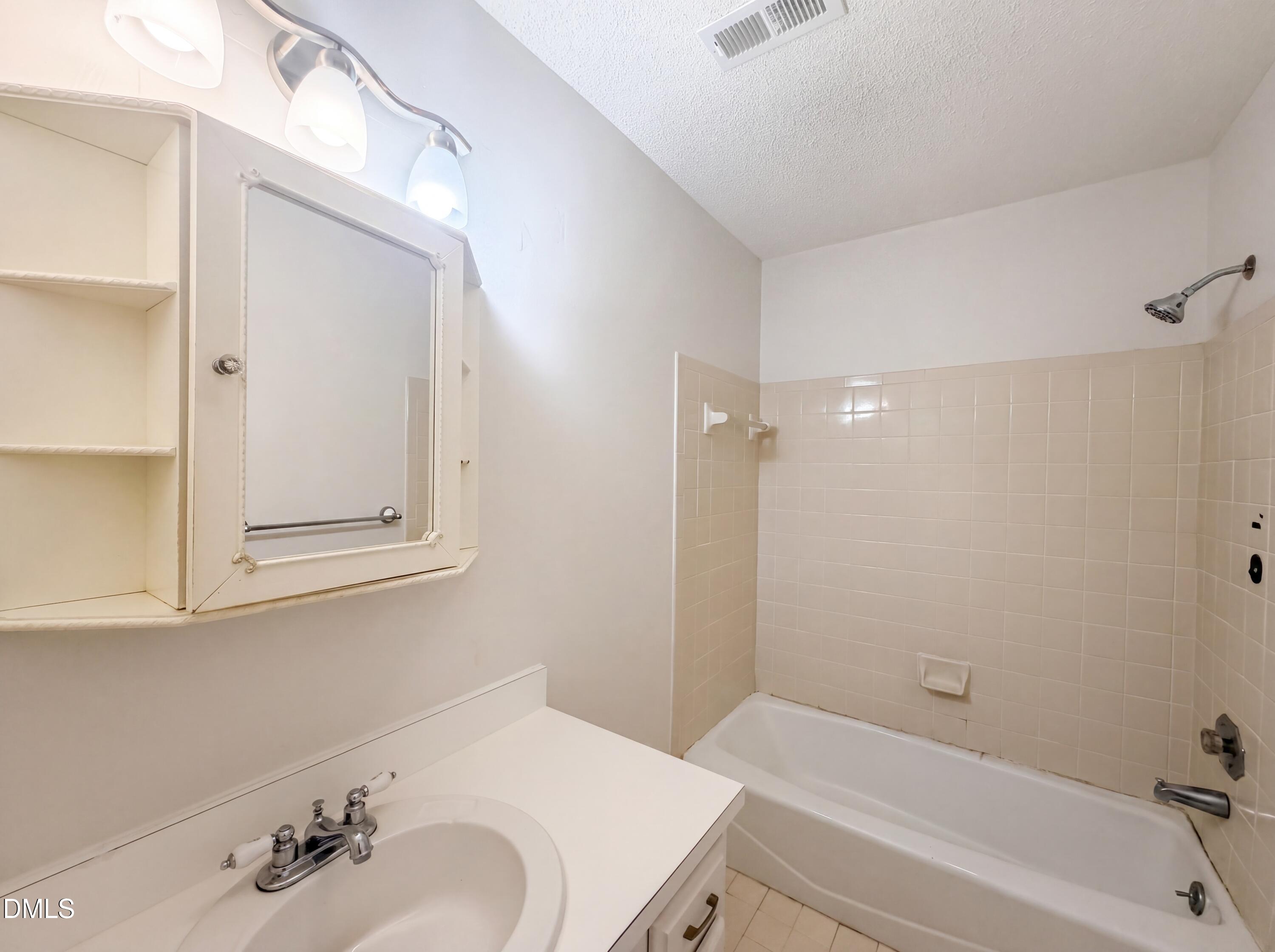 3921 Iron Horse Road Raleigh, NC 27616 - Photo 10 of 20 a bathroom with a bathtub and a sink