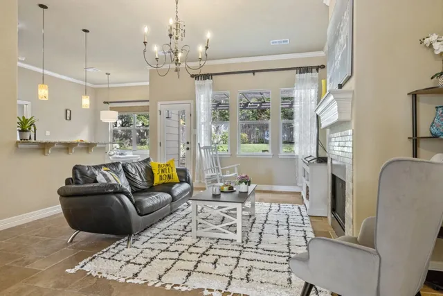 a living room with furniture fireplace and a chandelier