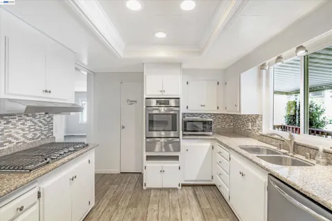 a kitchen with a sink stove and cabinets