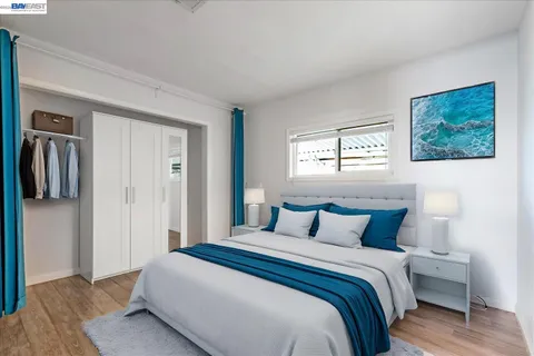 a bedroom with a bed and a painting on the wall