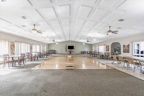 a large room with lots of furniture and a large window