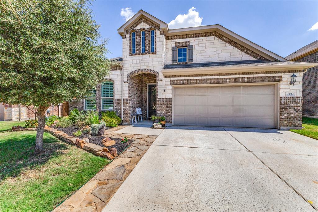 2402 Evans Road Corinth, TX 76210 - Photo 1 of 1 a front view of a house with garden