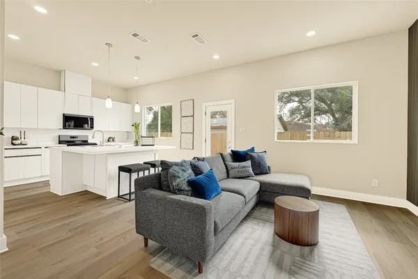 a living room with furniture and kitchen view