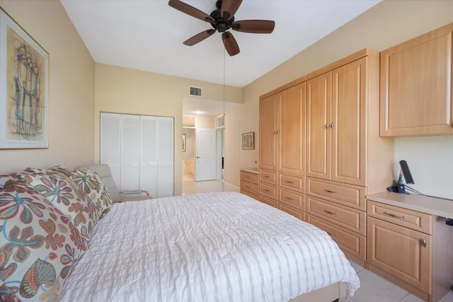 a bedroom with a bed and cabinets