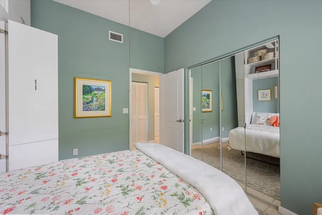 a bedroom with bed and glass door