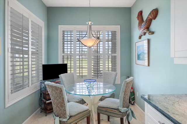 a view of a dining room with furniture and chandelier