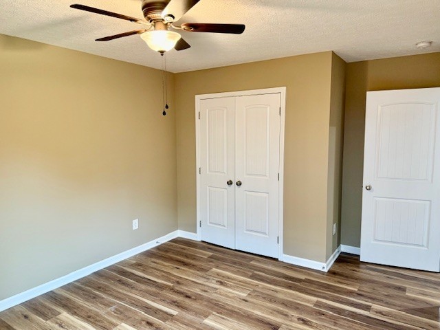 206 Hotel Street Decherd, TN 37324 - Photo 11 of 28 a view of a livingroom with wooden floor and a ceiling fan