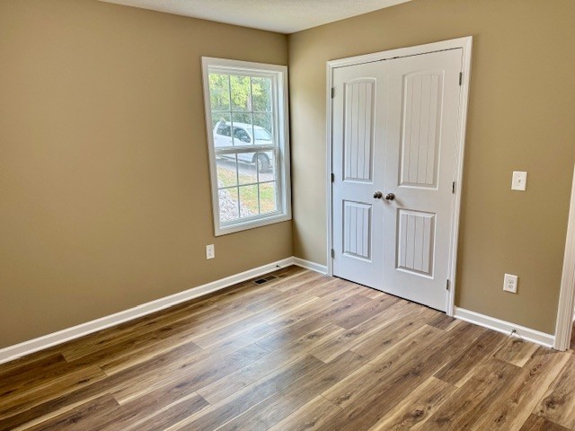 206 Hotel Street Decherd, TN 37324 - Photo 14 of 28 a view of an empty room with wooden floor and a window