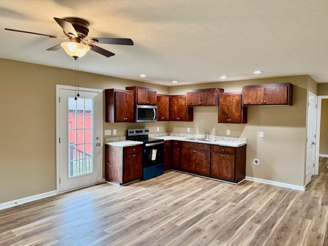 206 Hotel Street Decherd, TN 37324 - Photo 3 of 28 a large kitchen with stainless steel appliances granite countertop a refrigerator stove a sink dishwasher and wooden cabinets with wooden floor