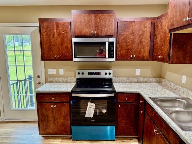 206 Hotel Street Decherd, TN 37324 - Photo 5 of 28 a kitchen with stainless steel appliances granite countertop a stove a sink and a microwave