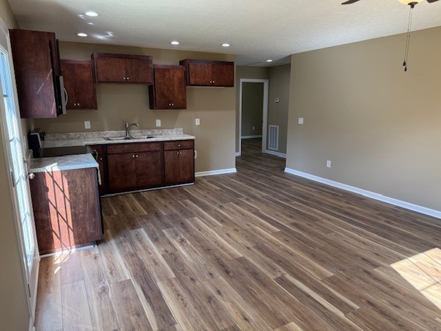 206 Hotel Street Decherd, TN 37324 - Photo 7 of 28 a kitchen with stainless steel appliances granite countertop a refrigerator a sink dishwasher a stove and white countertops with wooden floor