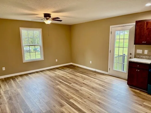 a view of empty room with wooden floor
