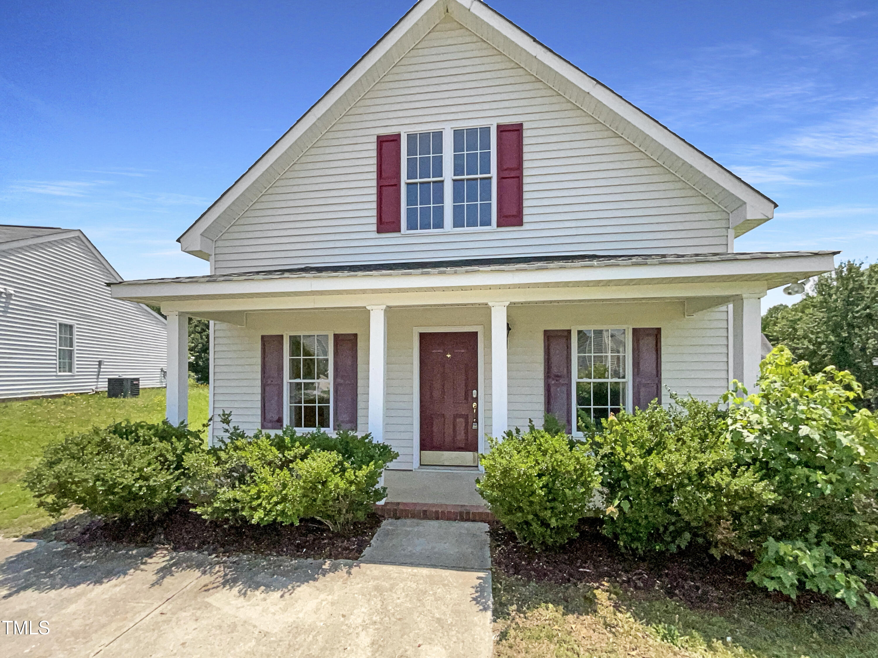 front view of brick house with potted plants