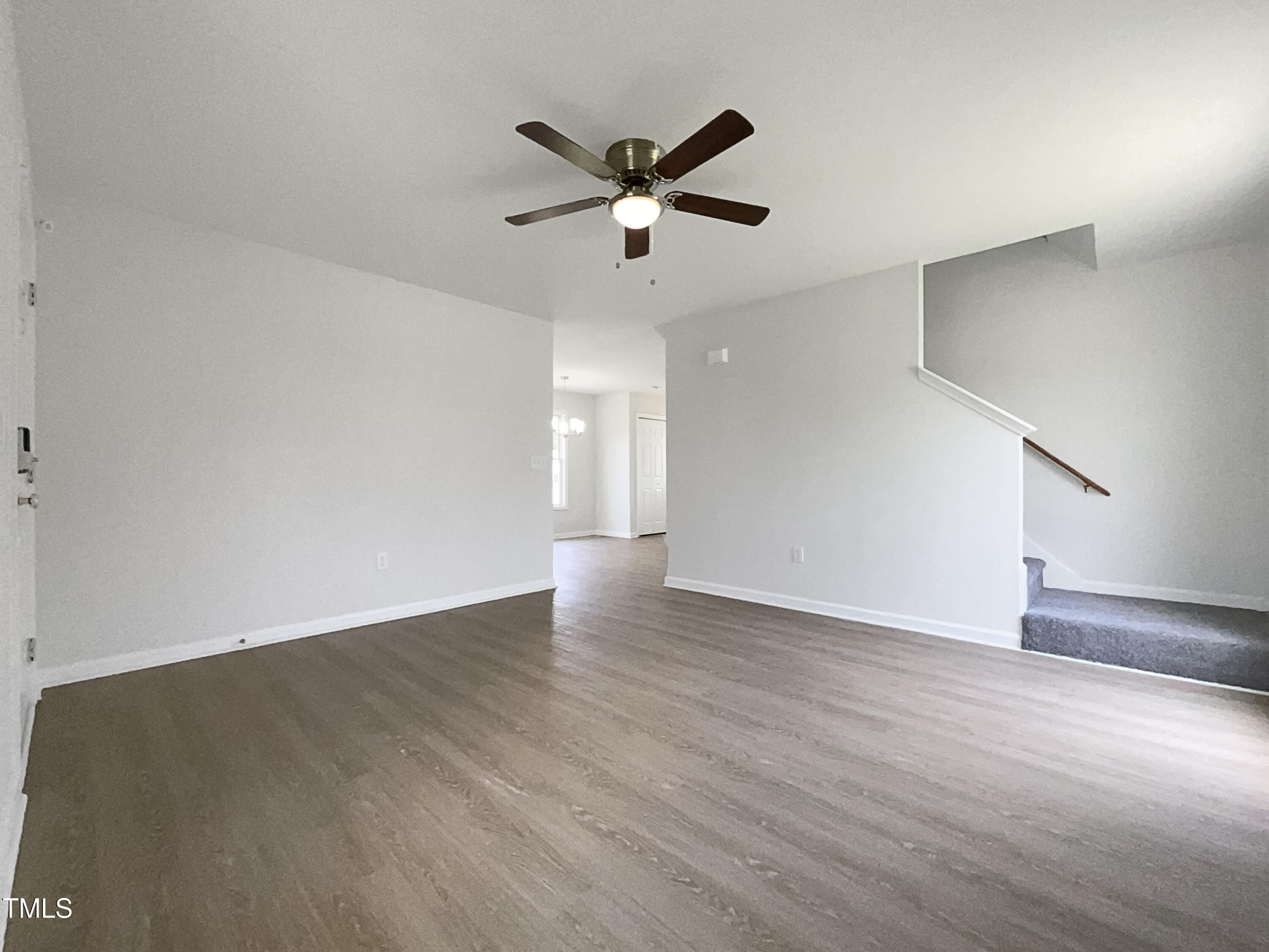4025 Scofield Drive Raleigh, NC 27610 - Photo 13 of 18 a view of an empty room with wooden floor