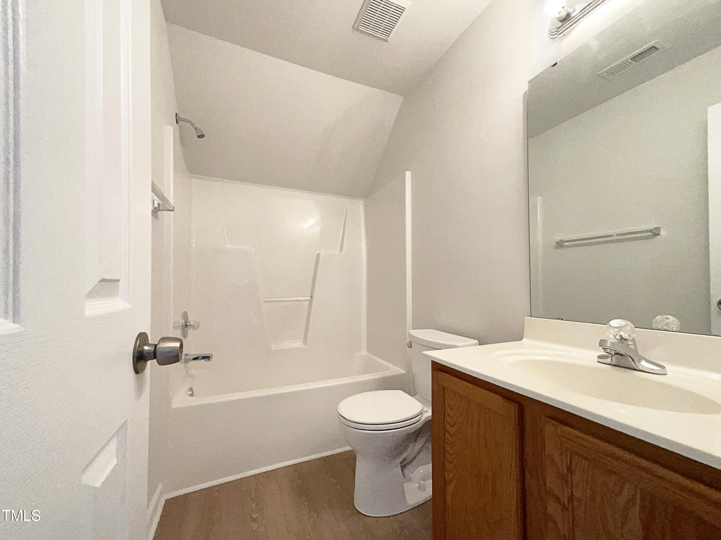 4025 Scofield Drive Raleigh, NC 27610 - Photo 14 of 18 a bathroom with a sink a toilet and a bathtub