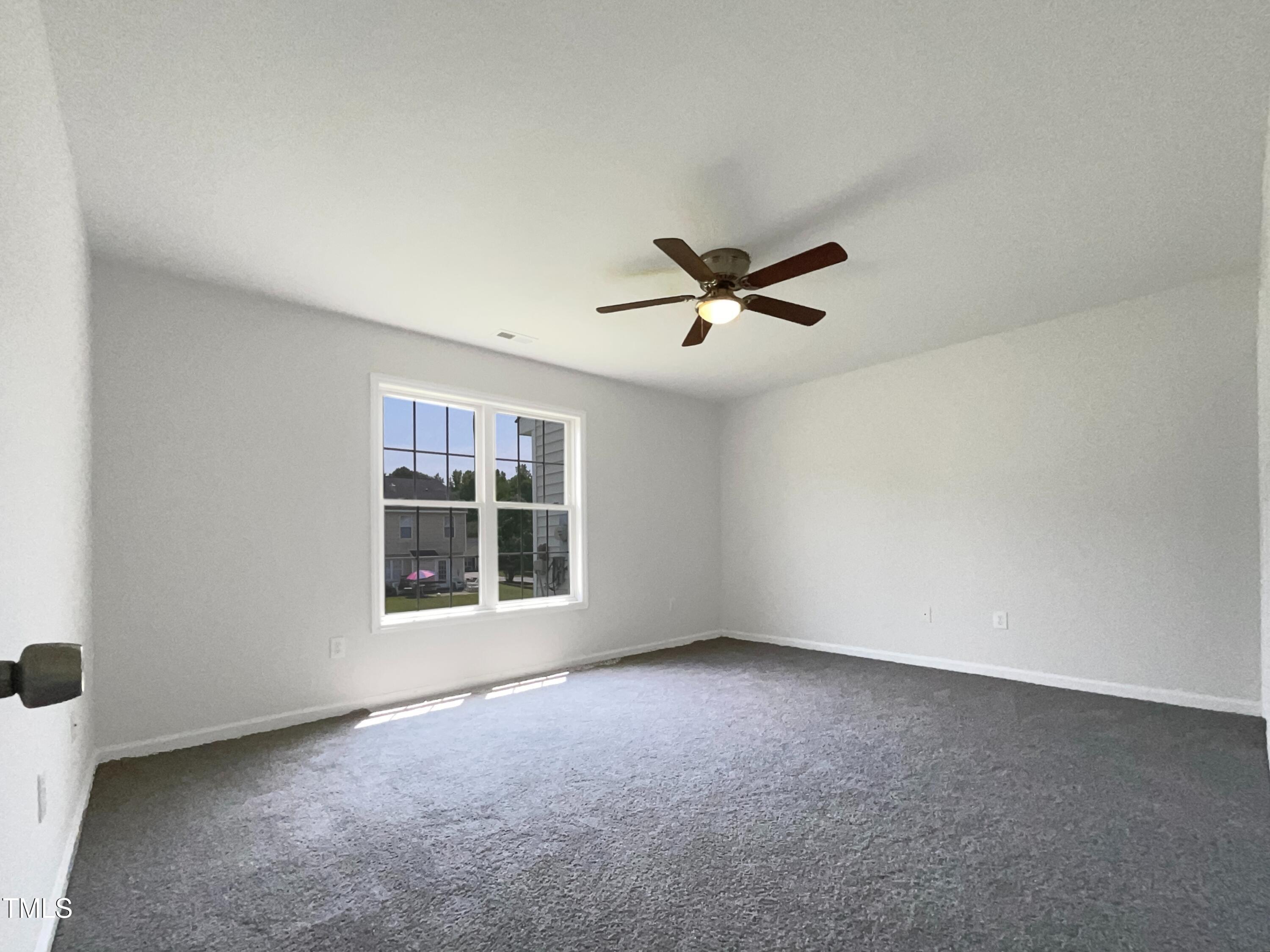 4025 Scofield Drive Raleigh, NC 27610 - Photo 15 of 18 an empty room with windows and ceiling fan