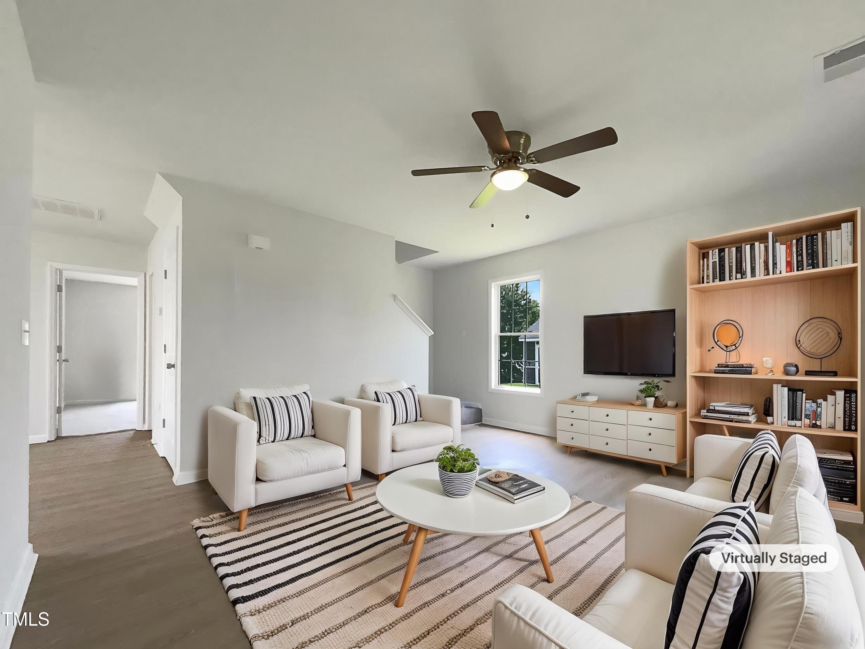 4025 Scofield Drive Raleigh, NC 27610 - Photo 2 of 18 a living room with furniture a rug and a flat screen tv
