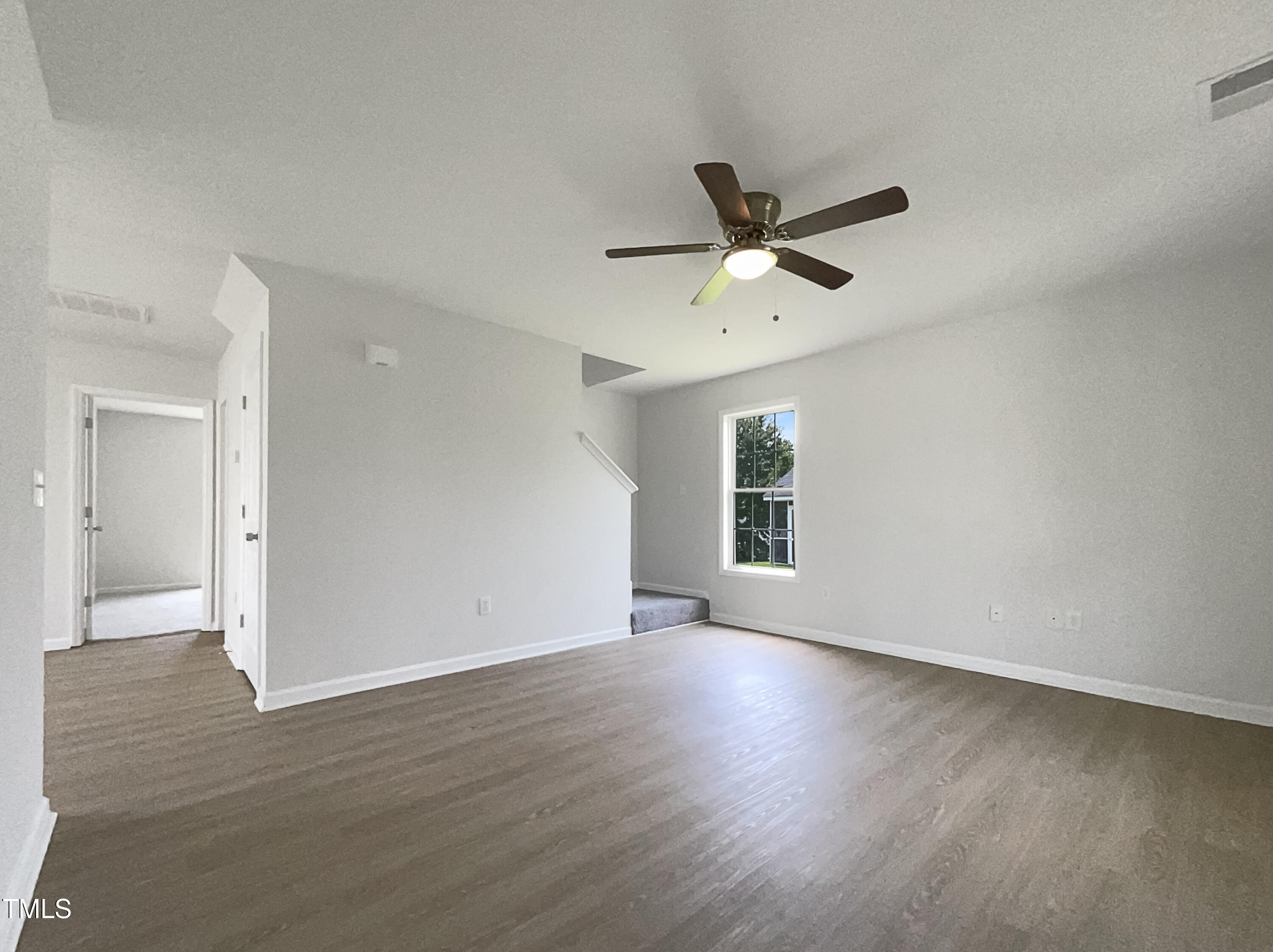 4025 Scofield Drive Raleigh, NC 27610 - Photo 3 of 18 an empty room with wooden floor and windows