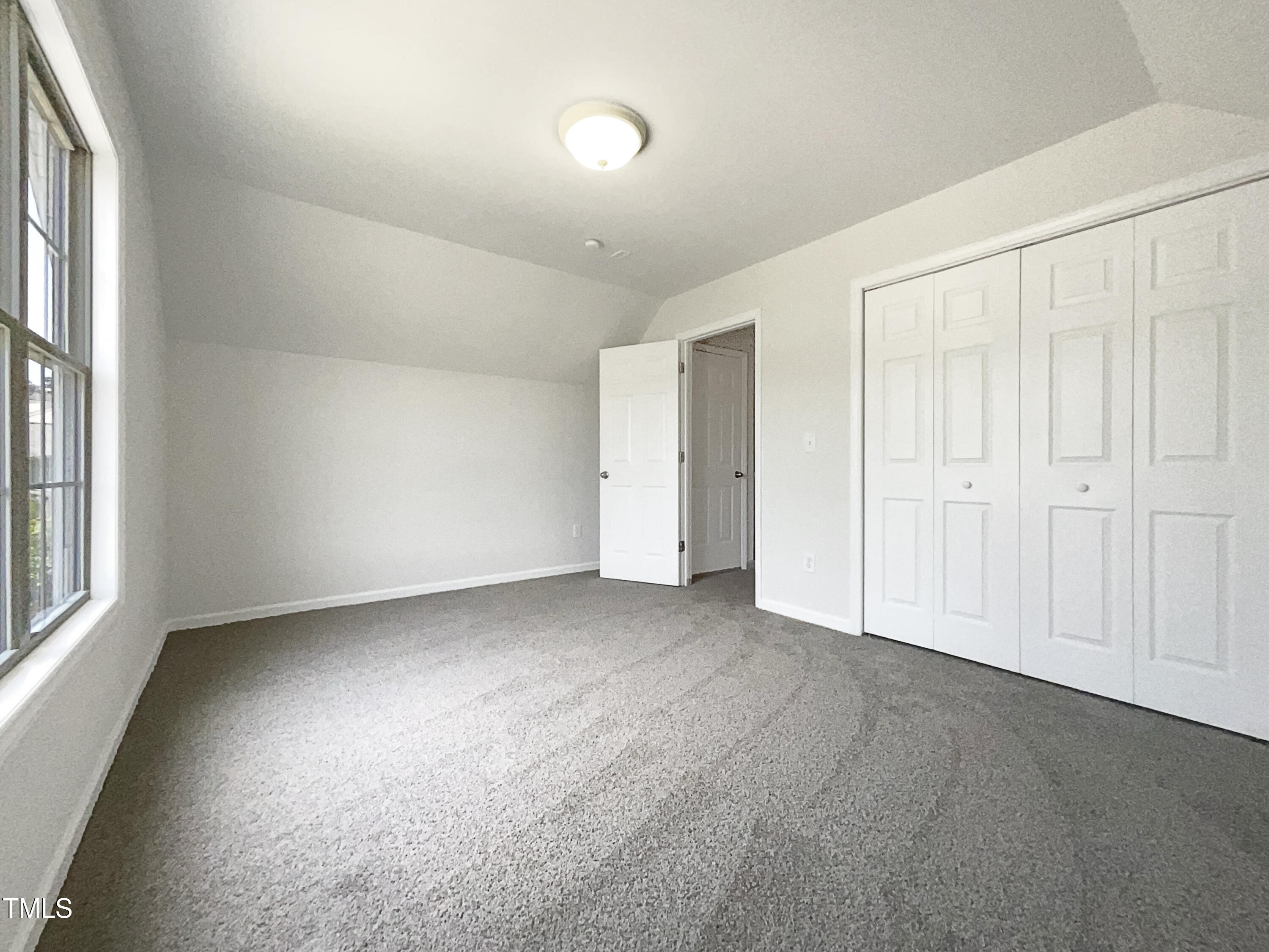 4025 Scofield Drive Raleigh, NC 27610 - Photo 5 of 18 an empty room with a empty space and windows