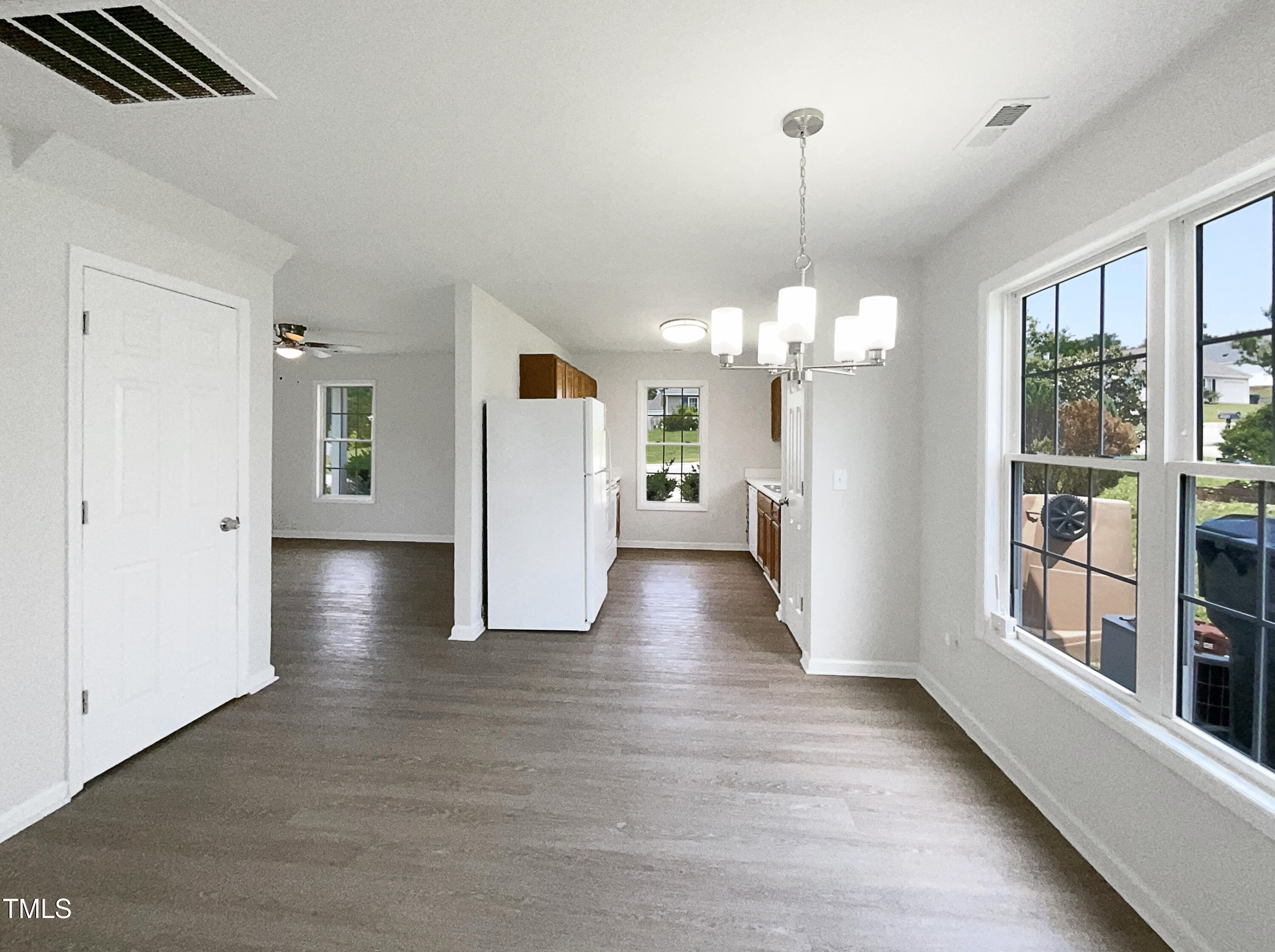 4025 Scofield Drive Raleigh, NC 27610 - Photo 9 of 18 a view of a big room with windows and chandelier