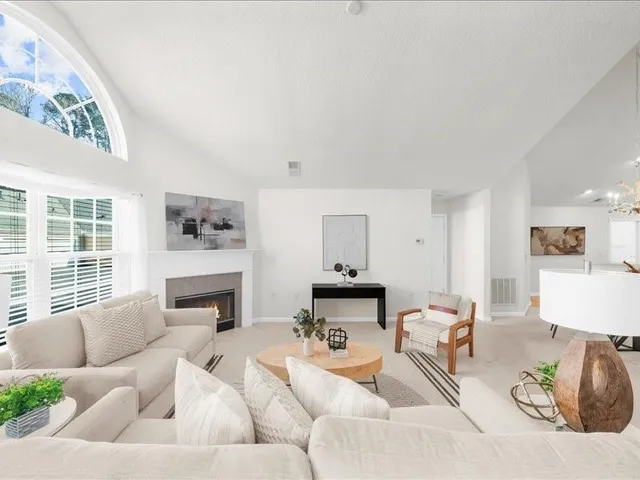 a living room with furniture fireplace and a flat screen tv