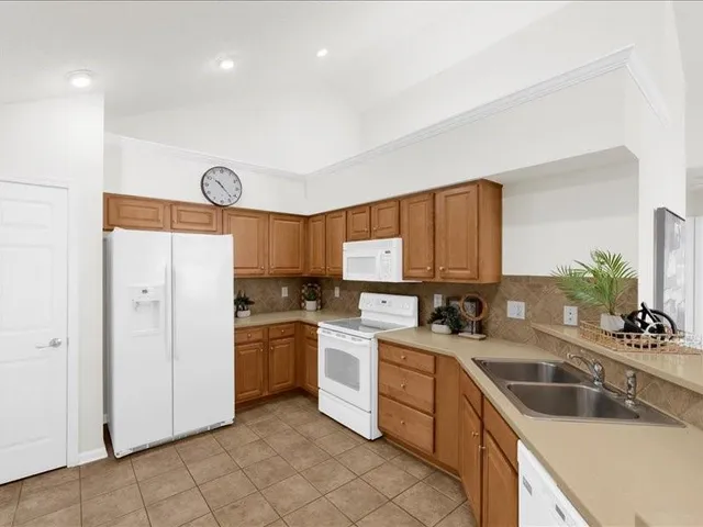 a kitchen with a sink cabinets and stainless steel appliances