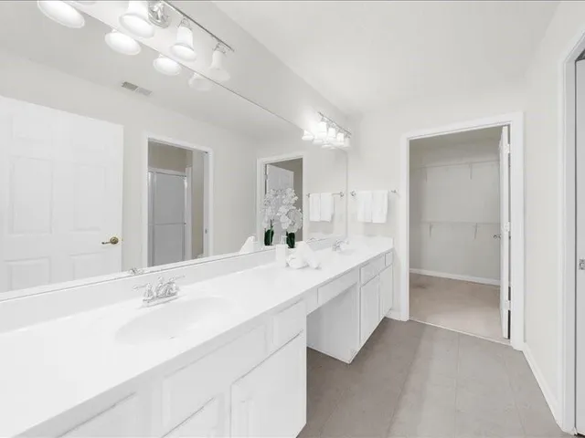 a bathroom with a sink vanity and a mirror