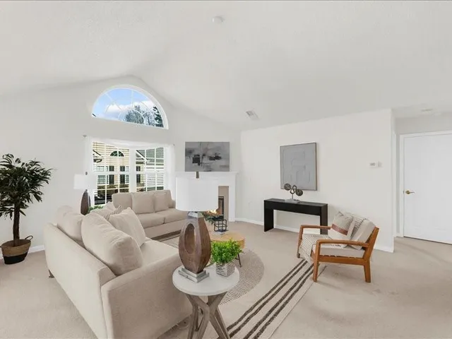 a living room with furniture and a table