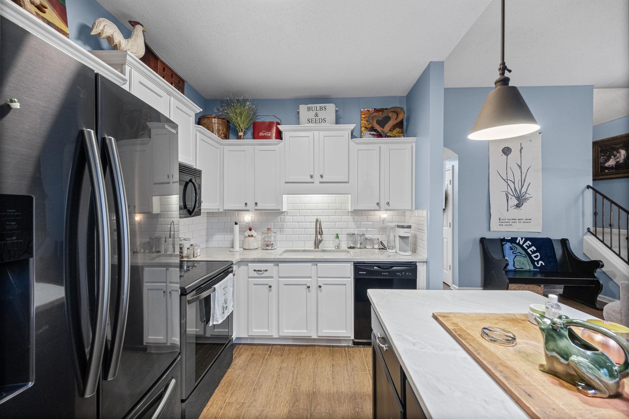 4950 Shaws Ridge Trail Arlington, TN 38002 - Photo 5 of 27 a kitchen with kitchen island a sink stove and refrigerator