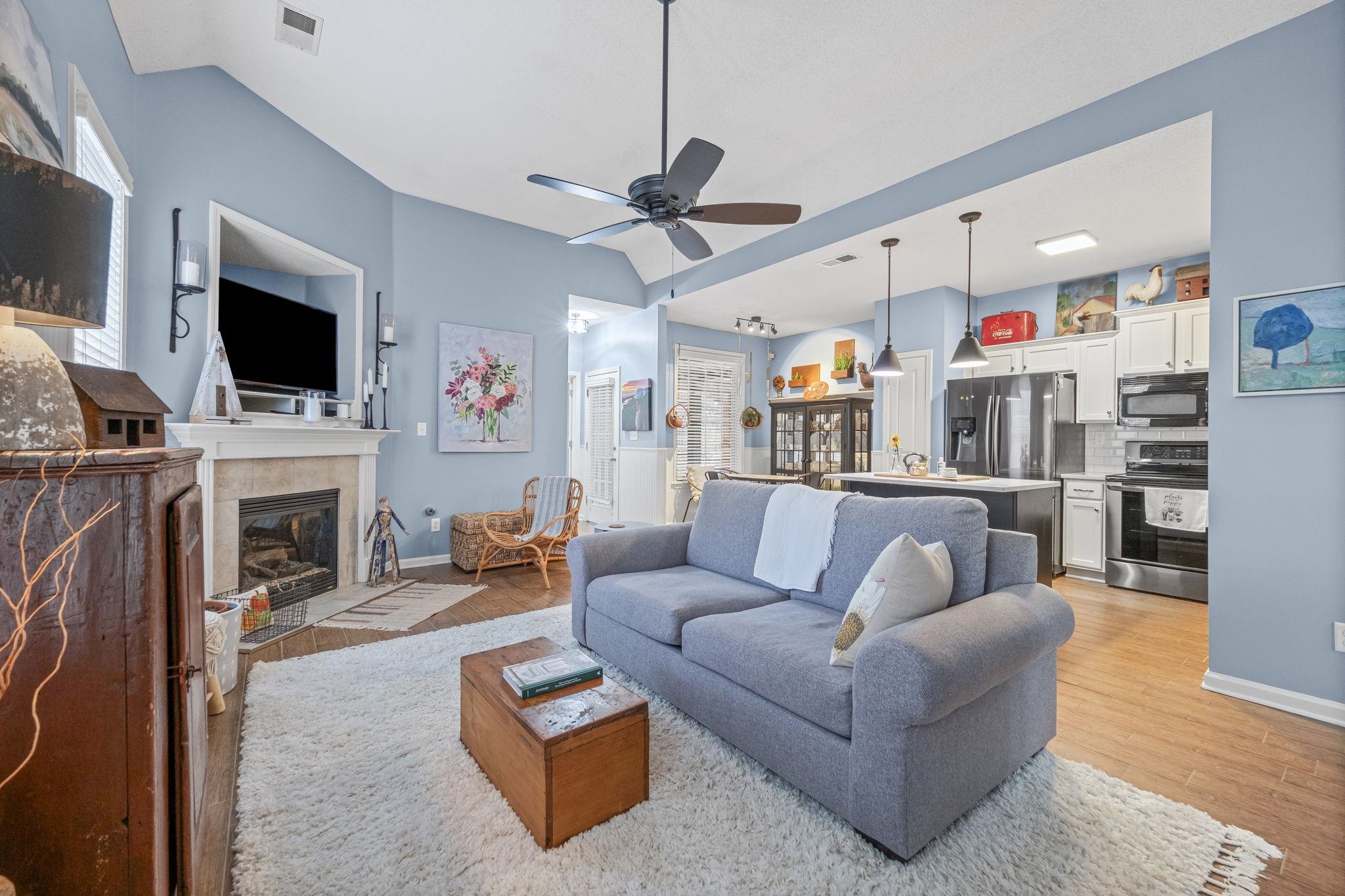 4950 Shaws Ridge Trail Arlington, TN 38002 - Photo 10 of 27 a living room with furniture a fireplace and a flat screen tv