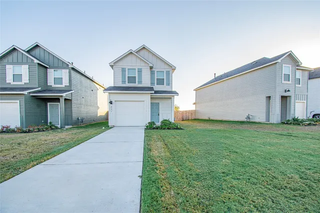 a view of a yard in front view of a house
