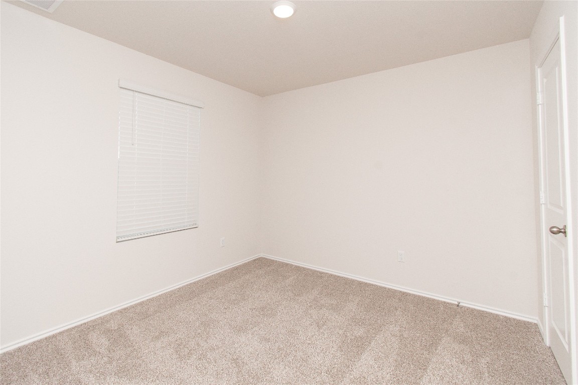 201 Varner Way Lockhart, TX 78644 - Photo 9 of 16 Empty room with carpet floors and recessed lighting