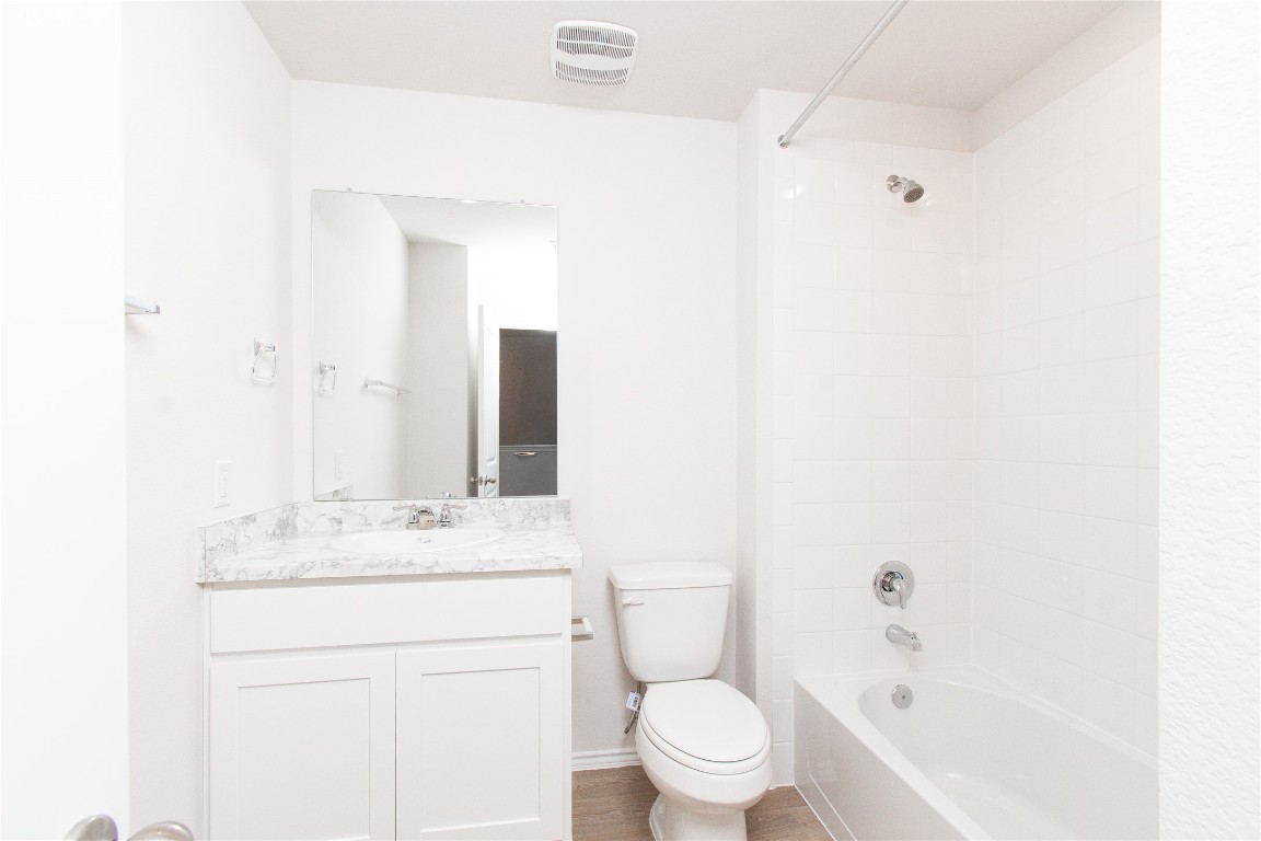 201 Varner Way Lockhart, TX 78644 - Photo 12 of 16 Full bathroom featuring shower / tub combination, vanity, and light wood finished floors