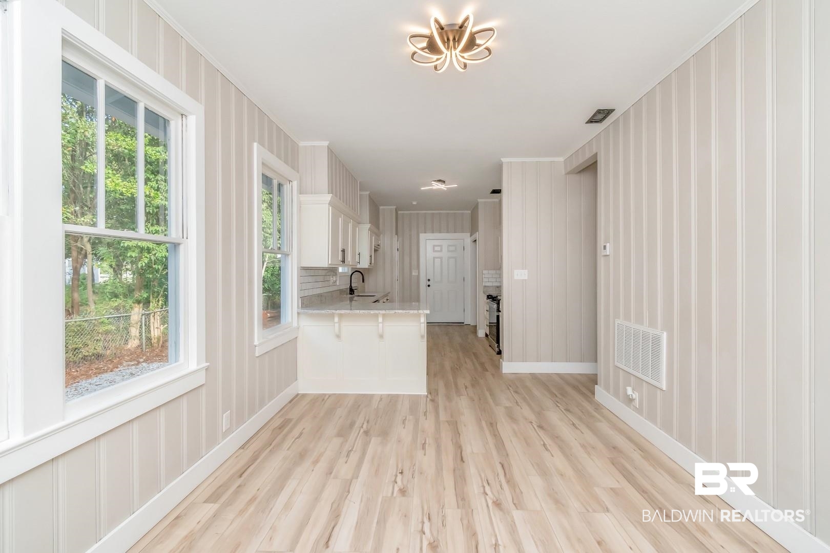 555 Michigan Avenue Mobile, AL 36604 - Photo 11 of 28 Unfurnished living room with light hardwood / wood-style floors, sink, and plenty of natural light
