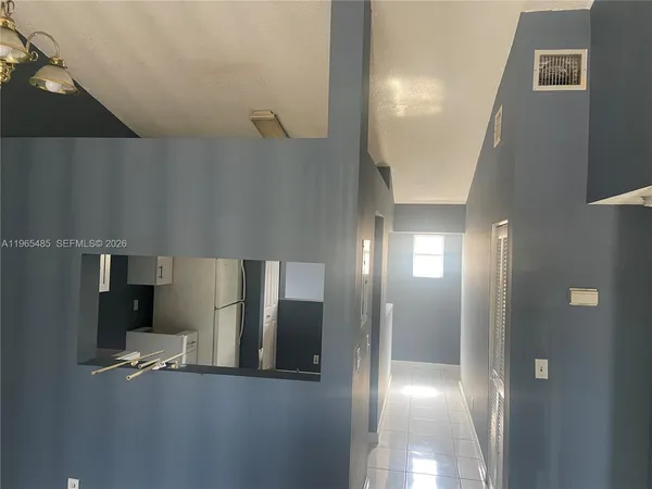 a view of a hallway with seating area