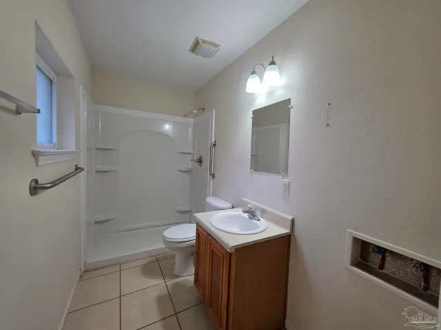 a bathroom with a double vanity sink toilet and a mirror