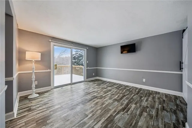 a view of an empty room with glass door