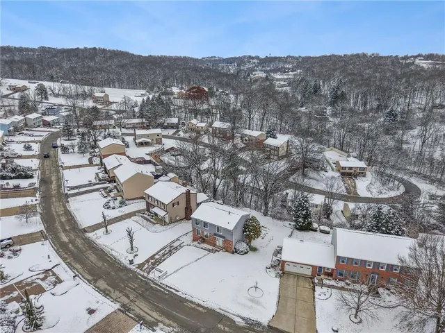 an aerial view of residential house with parking