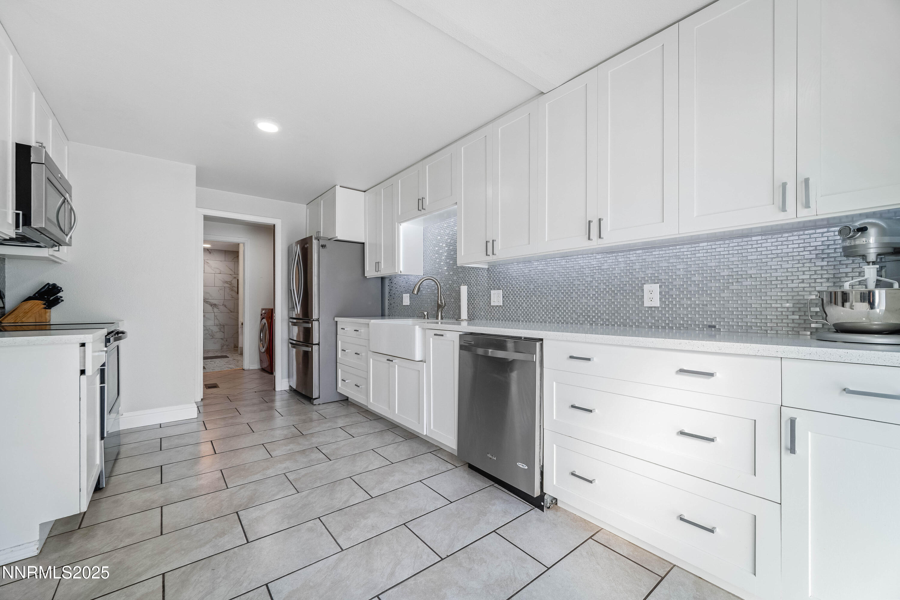 2154 Oppio Street Sparks, NV 89431 - Photo 9 of 21 a kitchen with white cabinets and white appliances