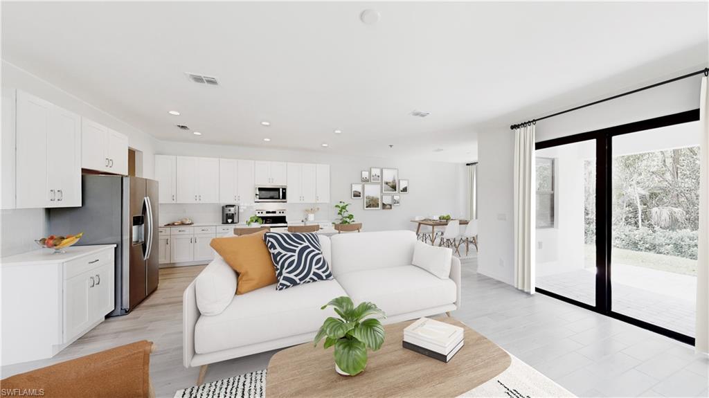 3114 Juniper Way Naples, FL 34112 - Photo 16 of 28 a living room with stainless steel appliances furniture and a large window