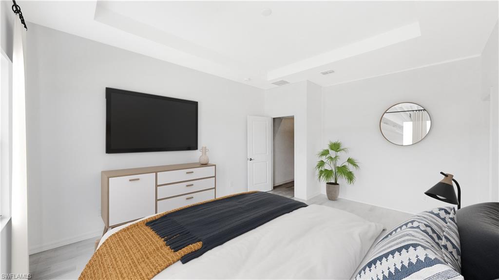 3114 Juniper Way Naples, FL 34112 - Photo 19 of 28 a bedroom with a bed and flat screen tv