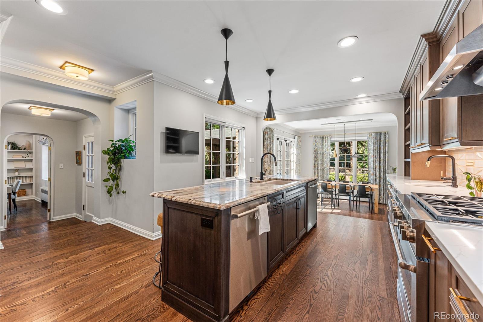28 Crestmoor Drive Denver, CO 80220 - Photo 15 of 45 a kitchen with stainless steel appliances granite countertop a stove and a wooden floors